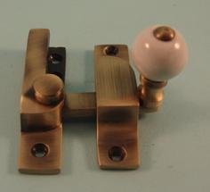 THD104N/AB Straight Arm Fastener - Narrow - Ceramic Knob in Antique Brass